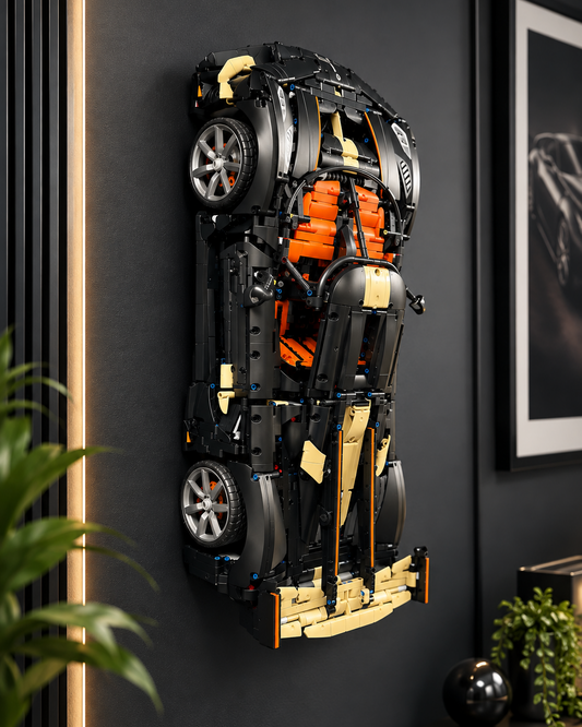 A lego Koenigsegg Sadair's Spear Megacar car model mounted on a dark gray wall in a modern interior setting with a plant and framed picture visible.